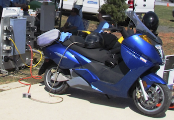 Electric motorcycle at charging station